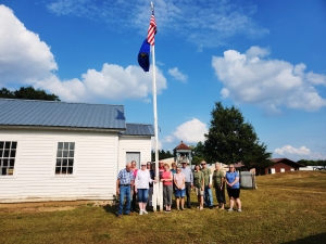 A new USA and Wisconsin State Flag were dedicated and sent flying at the Pioneer Log Village in Reedsburg. Both flags were donated by Rep. Tony Kurtz, R-Wonewoc, who was planning on attending the event but got caught up in field work, trying to stay ahead of the rain. The Star Spangled Banner was sung and the Pledge of Allegiance recited by the crowd before refreshments were served. 