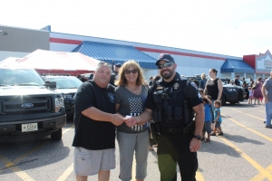 The Pearcy family presents a $100 check to Sgt. Mark Eberle of the Reedsburg Police Department for the K9 program.