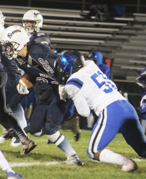 Running back Zach Bestor (No. 22) has his jersey pulled during this running play for the Beaver football team Friday night vs. Watertown. Bestor ran for 35 yards and a touchdown in Reedsburg’s 14-9 victory at Millennium Field. (Photo by Troy Matz)