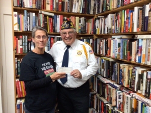 The Bargain Books Sale at Main Street Books raised $400 for the Cannon Memorial Project at Webb Park. Seen here are Store Owner Dana Westedt and American Legion Post 350 Commander Jesse Arias. The Legion is raising money to restore the cannon in the park. (Submitted photo)